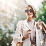 shopper carries paper bags with purchases